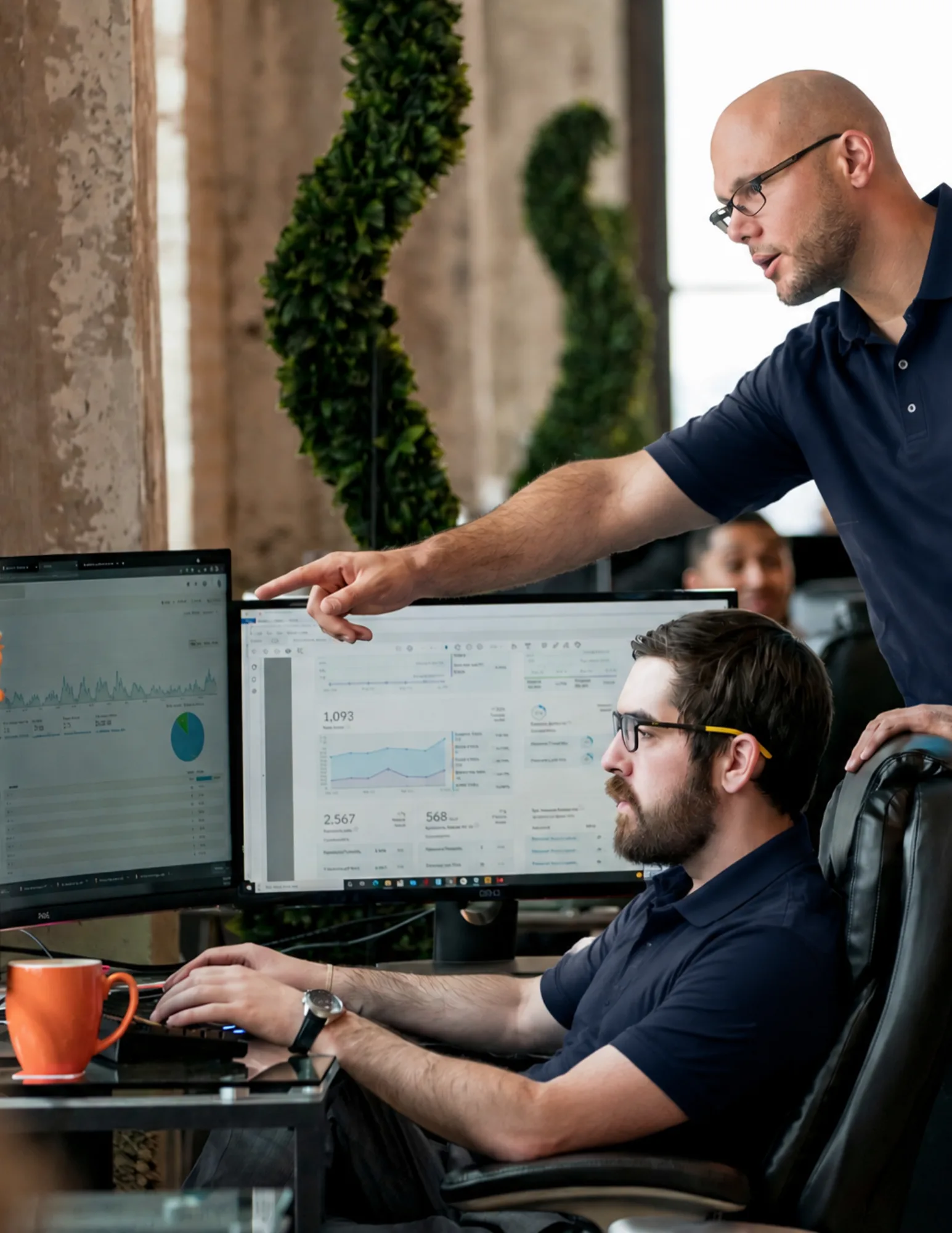 Business-It-Problems-Broward-County IT technicians reviewing live network monitoring metrics and system performance for a Broward County business.