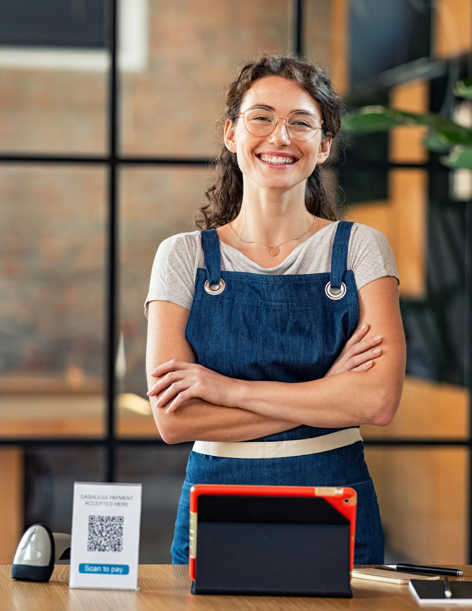Small business owner at a modern retail checkout counter, representing clients utilizing managed IT, networking, and cybersecurity services in South Florida and Tennessee.